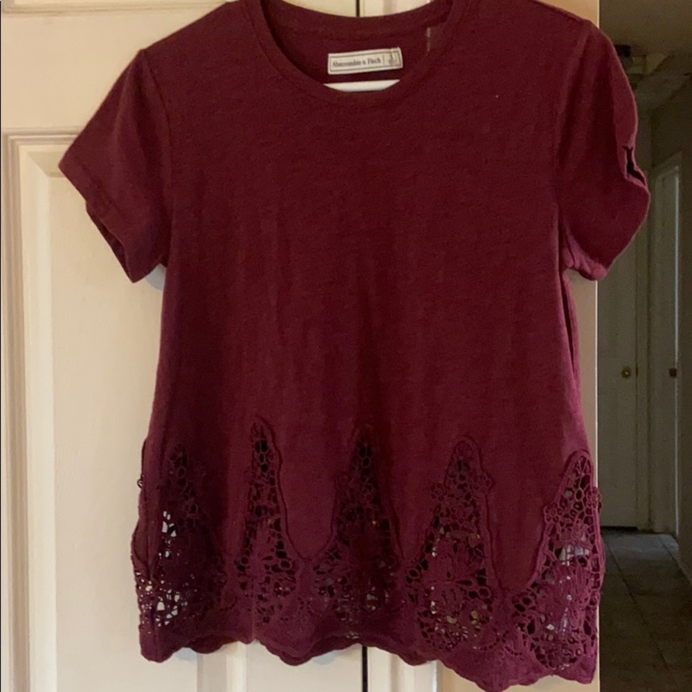 Maroon shirt sleeve with lace detail on bottom